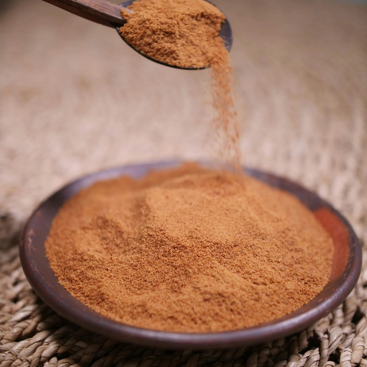 True Ceylon cinnamon powder with delicate cinnamon bark and fresh green leaves